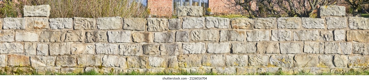 Rustic Rough Garden Wall Made Of Sandstone Blocks.