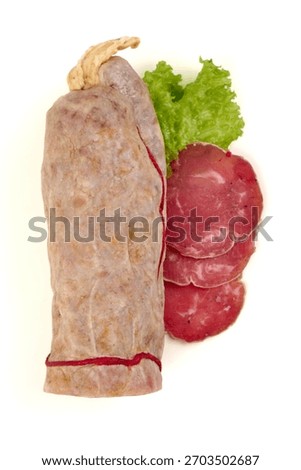Rustic saucisson sec featuring sliced cured meat and a whole sausage with lettuce, isolated on white background