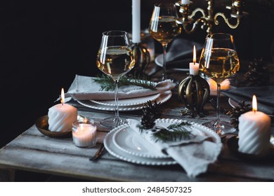 Rustic Scandinavian style zero waste eco-friendly dinner table decor for Christmas or new year family celebration. Wooden table, natural elements like pine cones, fir tree branches, candles - Powered by Shutterstock