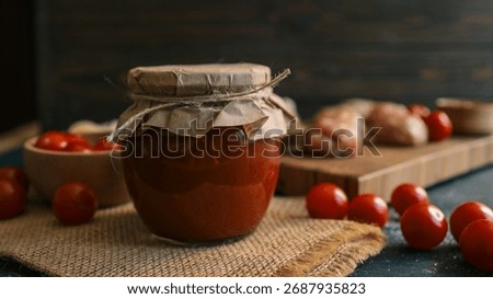 A rustic scene featuring a jar of tomato sauce, surrounded by fresh tomatoes and other ingredients, evoking a sense of homemade goodness and culinary preparation.