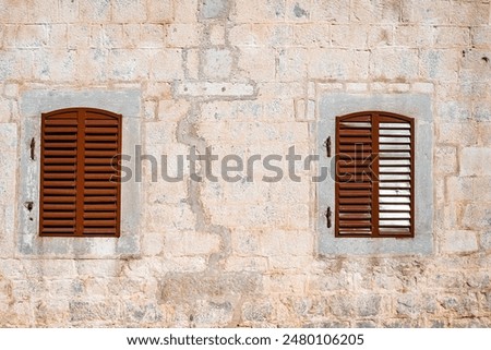Rustic Shuttered Windows on Stone Wall