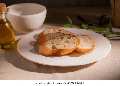 Rustic Sliced Artisan Bread with Olive Oil on White Plate, Cozy Food Photography