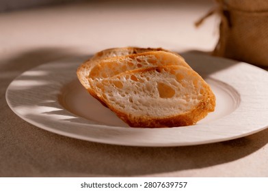 Rustic Sliced Artisan Bread with Olive Oil on White Plate, Cozy Food Photography