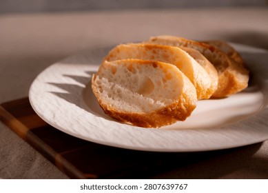 Rustic Sliced Artisan Bread with Olive Oil on White Plate, Cozy Food Photography