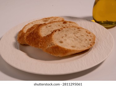 Rustic Sliced Artisan Bread with Olive Oil on White Plate, Cozy Food Photography