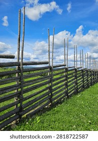 Rustic Split-Rail Fence Under Blue Summer Sky