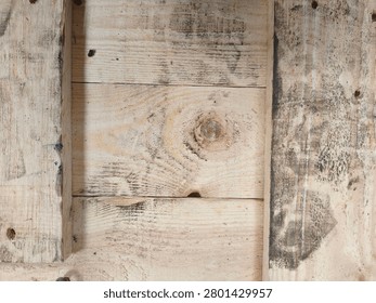 Rustic square panel section of a light timber container crate showing various grain textures and smudges.