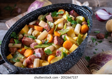 Rustic Stew For Autumn Or Winter Cooked With Root Vegetables  And Pork Meat Served In A Rustic Pot On Wooden Table Closeup And Top View