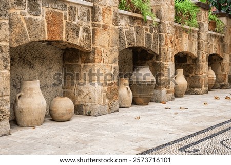 Similar – Image, Stock Photo A Mediterranean courtyard, the curved facade of a residential building and a delicate flower