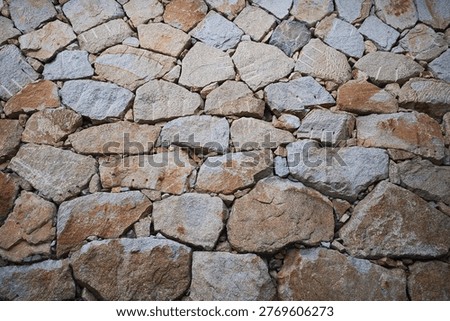 Rustic stone wall texture background, irregular masonry pattern