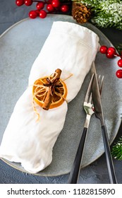 Rustic table setting for festive Christmas dinner on concrete table with decoration