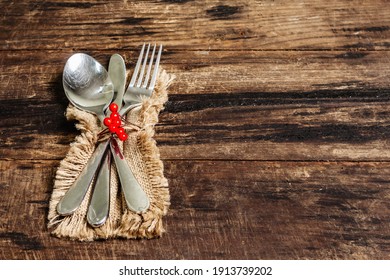 Rustic Table Setting For St Valentine's Dinner. Sackcloth Napkin, Cutlery And Festive Decor. Vintage Wooden Boards Background