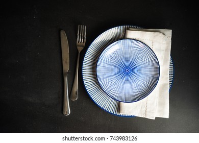 Rustic table setting with vintage flatware onn dark wooden table