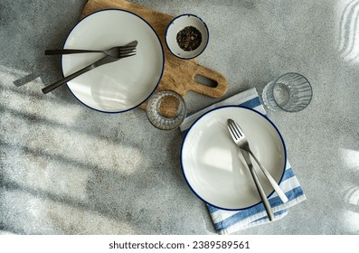 Rustic table setting with white and blue stripe tableware - Powered by Shutterstock