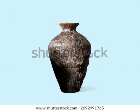Rustic Textured Earthenware Vase on the Blue Background