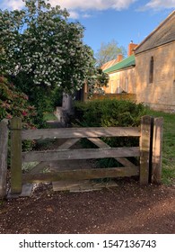 Rustic timber gate stone building