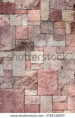 Rustic warm stone cladding wall texture with natural earthy tones.