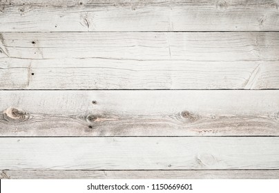 Rustic weathered wood surface with long boards lined up. Wooden planks on a wall or floor with grain and texture. Multicolor background with light bleached flat neutral tones.
