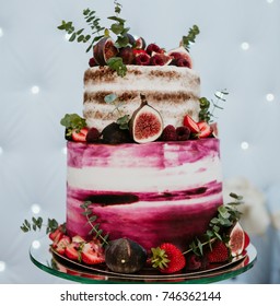Rustic wedding cake decorated with figs and greenery