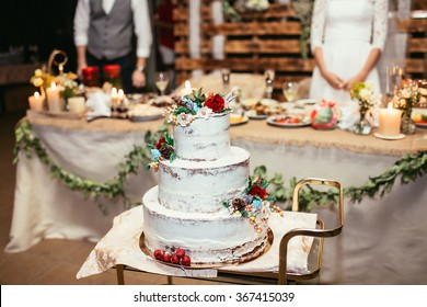 Rustic Wedding Cake On Wedding Banquet With Red Rose And Other Flowers