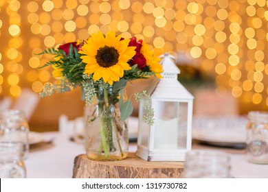 Rustic Wedding Centerpiece Decor At Barn Reception With Bokeh In Background