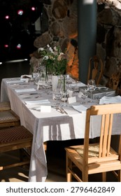 Rustic Wedding Reception Table Decorated With Seasonal Flowers and Elegant Tableware in Historic Venue Interior