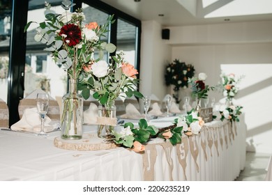 Rustic Wedding Reception Top Table Seating With Glasses, Cutlery And Dishes