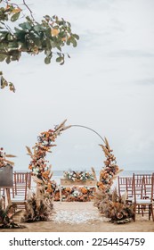 Rustic wedding set up on beach. Beautiful tropical outdoor ceremony or party with ocean view. Luxury destination weddings concept