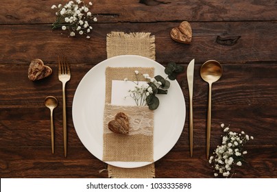 Rustic Wedding. Vintage gold cutlery with eucalyptus an old wooden background.  - Powered by Shutterstock