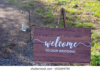 Rustic Welcome To Wedding Wooden Sign Outside On Path