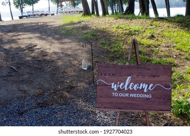 Rustic Welcome To Wedding Wooden Sign Outside On Path