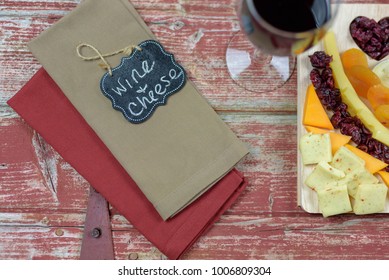 Rustic Wine And Cheese Flat Lay On Red Barnwood Background