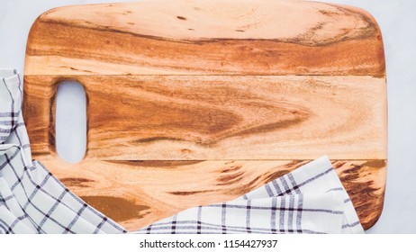 Rustic Wood Cutting Board On Marble Kitchen Counter.