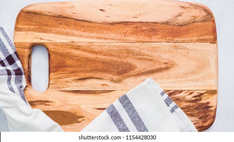 Rustic Wood Cutting Board On Marble Kitchen Counter.