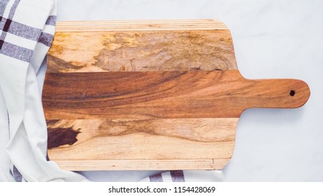 Rustic Wood Cutting Board On Marble Kitchen Counter.