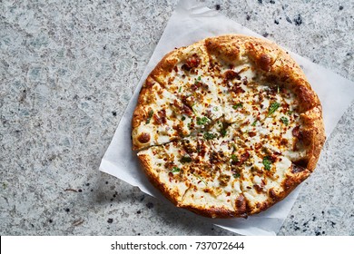rustic wood fired pizza on granite surface shot top down with copy space composition