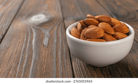Rustic Wood Table with White Ceramic Bowl Filled with Fresh Almonds