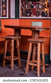 Rustic Wooden Bar Table and Stools Outside Traditional Pub with Vintage Window Display