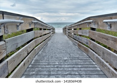 A rustic wooden boardwalk is a common sight in Florida beaches such as at the Indian Rocks beach where beachgoers are led to the serene and beautiful waters of Gulf of mexico
