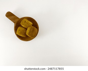 A rustic wooden bowl overflowing with fresh bread rolls on a crisp white background. a collection of bread rolls overflowing from a round wooden bowl. - Powered by Shutterstock