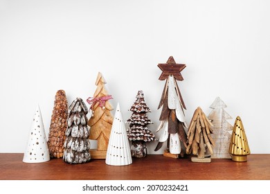 Rustic Wooden Christmas Tree Decor On A Wood Shelf Against A White Wall Background