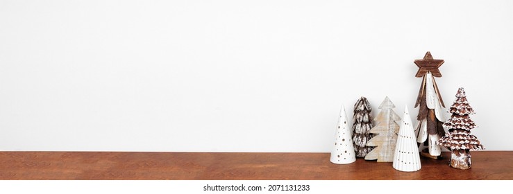 Rustic Wooden Christmas Tree Decor On A Wood Shelf Against A White Wall Banner Background With Copy Space