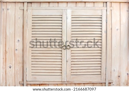 Rustic wooden cupboard. Handmade wooden locker in country style with louvered doors. Old cabinet in colonial style