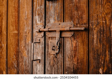 A Rustic Wooden Door featuring a Vintage Lock that adds charm and character to any space - Powered by Shutterstock