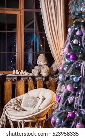 Rustic Wooden Living Room With Big Windows, Decorated Lilac Christmas Tree And Cozy Papasan Chair