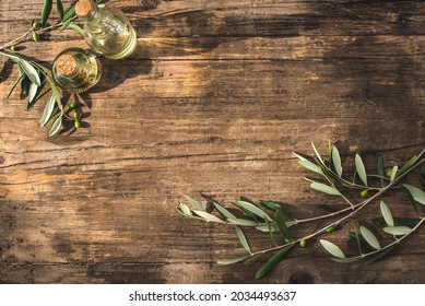 Rustic wooden olive background with olive oil and olive branches, sunlight for graphic design and text, copy space, flat lay - Powered by Shutterstock - Get 15% off with code: PIKWIZARD15