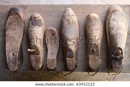 Rustic wooden shoe lasts on wooden surface
