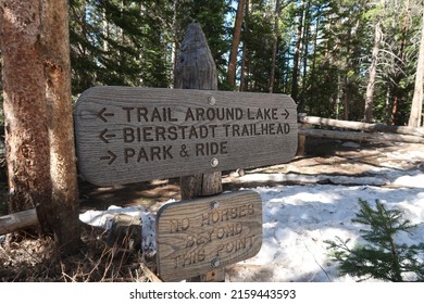 Rustic wooden sign for Bierstadt Lake trail at Rocky Mountain National Park. Trail around lake. Trailhead. Park and ride. No horses beyond this point. - Shutterstock ID 2159443593
