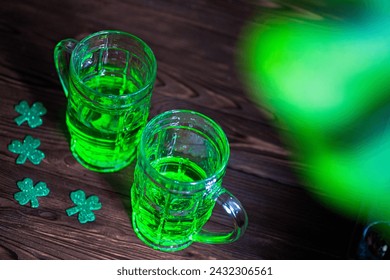 rustic wooden table adorned with two glasses of frothy green Irish beer. reflecting the festive ambiance of St. Patrick's Day celebrations in a cozy pub setting. - Powered by Shutterstock