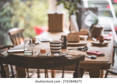 A rustic wooden table is set for breakfast with an egg, bread, and a striped coffee cup, creating a cozy atmosphere